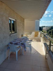 a patio with a table and chairs on a balcony at Apartamentos CT in Salou