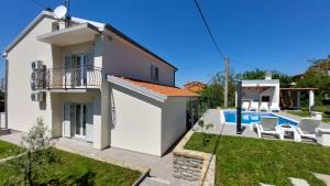 a villa with a swimming pool and a house at Villa Amoena with Pool and Sauna in Brtonigla