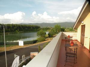 a balcony with chairs and a view of a river at Cameracaffè sul Lago in Arezzo