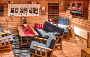 a living room with a couch and a table at Awesome Home In Hvringen With Sauna in Høvringen