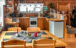 a kitchen with a table and chairs in a cabin at Awesome Home In Hvringen With Sauna in Høvringen