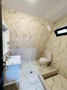 biała łazienka z toaletą i umywalką w obiekcie House of memories w mieście Surami