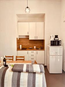 a kitchen with two beds and a microwave at Apartment Paolo in Senj