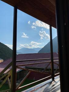 a view from the window of a house with mountains at B & B Juta in Stepantsminda