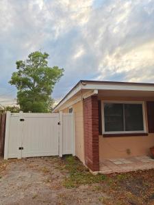 a house with a white fence and a garage at Amazing guest unit central location in St Petersburg