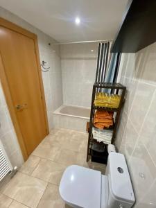 a bathroom with a toilet and a bath tub at Coast apartment near Barcelona in Sant Andreu de Llavaneres +26 photos