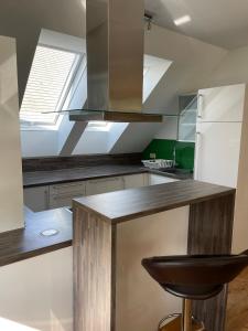 a kitchen with a wooden counter and a window at Ferienwohnung Igerc in Feistritz ob Bleiburg