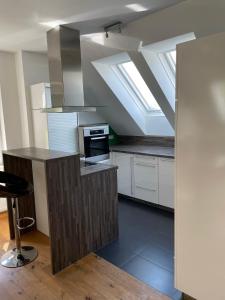 an attic kitchen with skylights and a stove top oven at Ferienwohnung Igerc in Feistritz ob Bleiburg