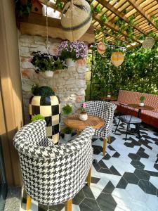 a patio with chairs and a table and a stone wall at Wolf Suites in Antalya
