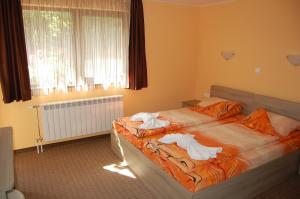 A bed or beds in a room at Guest House Savina