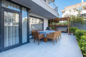 a dining room with a table and chairs on a patio at Wolf Suites in Antalya
