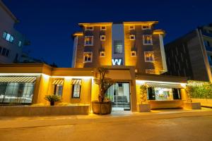 a building with a palm tree in front of it at Wolf Suites in Antalya
