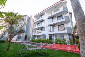 an apartment with a lawn in front of a building at Wolf Suites in Antalya