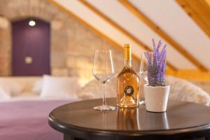 a table with a bottle of wine and two glasses at Vanjaka bed and breakfast in Trogir