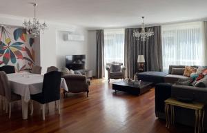 a living room with a couch and a table at Secure, Spacious, and Eclectic 1 to 3 Bedroom Apartments w Pool, Garden, Private Parking, Tennis Basketball Football Courts and Concierge close to Istinye Park, Turkish Tennis Federation, and Acibadem Maslak in Istanbul