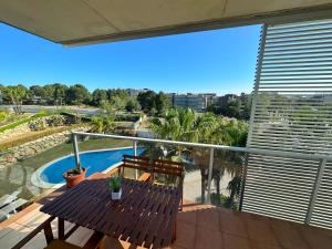 a balcony with a table and chairs and a pool at Domuum Holidays - PARADISE VILLAGE in Salou