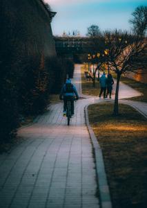 a person riding a bike down a sidewalk at Karlsburg Studio in Alba Iulia