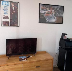 a flat screen tv sitting on top of a wooden dresser at Almara Inn in Tucumcari