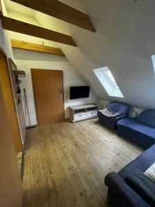 a living room with a couch and a flat screen tv at Hof Bahrenwinkel in Osterholz-Scharmbeck