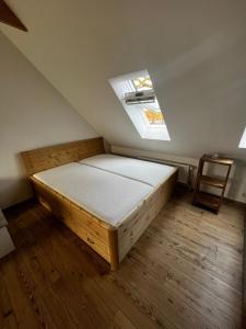 a bedroom with a bed and a skylight at Hof Bahrenwinkel in Osterholz-Scharmbeck