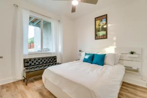 a white bedroom with a large bed and a window at Lago Vista Home with Game Room and Outdoor Tub! in Lago Vista