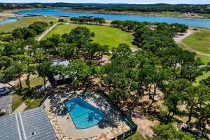 an overhead view of a swimming pool and trees at Lago Vista Home with Game Room and Outdoor Tub! in Lago Vista