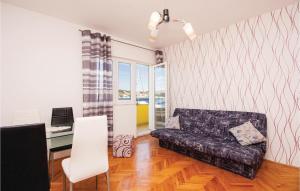 a living room with a couch and a desk at Cozy Apartment In Sibenik With House Sea View in Krapanj