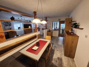 a living room with a table and a kitchen at Apartma CIK in Bovec
