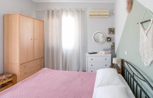 a bedroom with a bed and a dresser and a window at The City Apartment in Lixouri