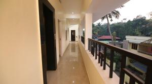a hallway of a house with a balcony at Thanungattil Towers in Changanācheri
