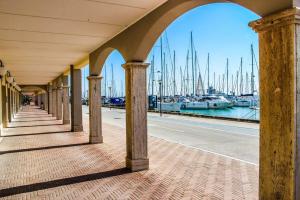 a bridge with a view of a marina with boats at Lavinia house in Lido di Ostia