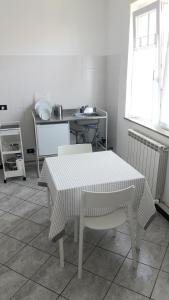 - une cuisine avec une table, des chaises et un évier dans l'établissement Appartamento a Lecco sul Lago di Como, à Lecco