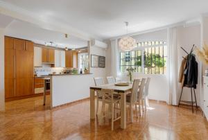 a kitchen and dining room with a table and chairs at Beautiful duplex apartment in Fuengirola in Fuengirola