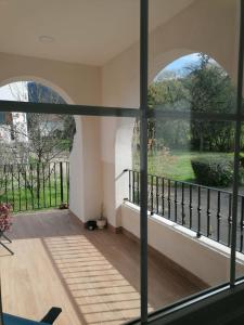 a room with a view of a garden through a window at El Manzanal - gateway to the mountains and Bilbao in Llodio