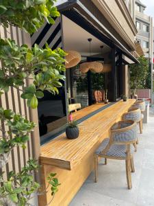 a wooden deck with chairs on the side of a building at Wolf Suites in Antalya