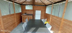 a kitchen with a table and chairs in a house at Yurta Agricamping Villamagra in Santa Luce