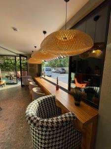 a restaurant with a long counter with chairs and lights at Wolf Suites in Antalya