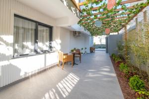 an outdoor patio with a pergola and a table at Wolf Suites in Antalya