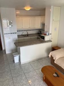 a kitchen with a counter with a microwave on it at Victoria Court 2, Los Cristianos in El Guincho