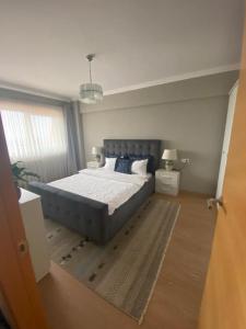 a bedroom with a large bed in a room at Dora City Apartament in Cluj-Napoca