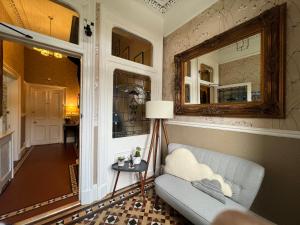 a living room with a couch and a mirror at Gladstone House in Edinburgh