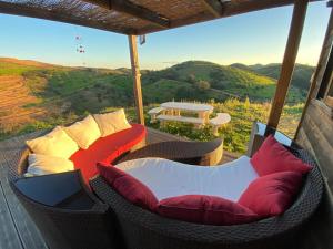 a balcony with chairs and a table with a view at Portugals Infinity - Fantástica casa de campo com vista de mar in Tavira