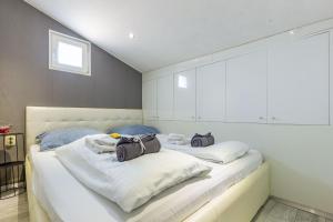 a bedroom with two beds with bags on them at Alpha loft 1BR apartment in center in Zadar