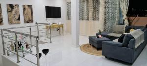 a living room with two couches and a television at Cazinos Apartamento in Praia