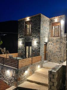 a stone house with a deck with lights on it at Casa Marel in Vlikhádha