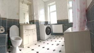 een badkamer met toilet, wastafel en wasmachine bij Klaipeda,Lithuania in Klaipėda