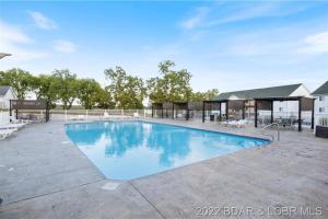 a large swimming pool with blue water at Most Exquisite View on the Lake! USA Themed fun condo! Host dedicated to creating your next memorable vacation! in Kaiser