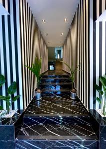 a lobby with black and white striped walls and potted plants at Wolf Suites in Antalya