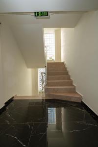 a room with a staircase with black marble floors at Wolf Suites in Antalya