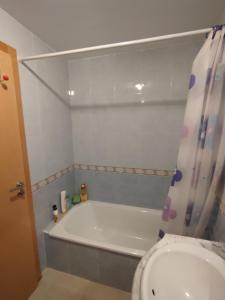 a bathroom with a bath tub and a toilet at Apartamento Ático Laguna Beach Almerimar in Almería